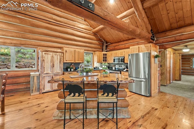 kitchen featuring stainless steel appliances, rustic walls, and light brown cabinets