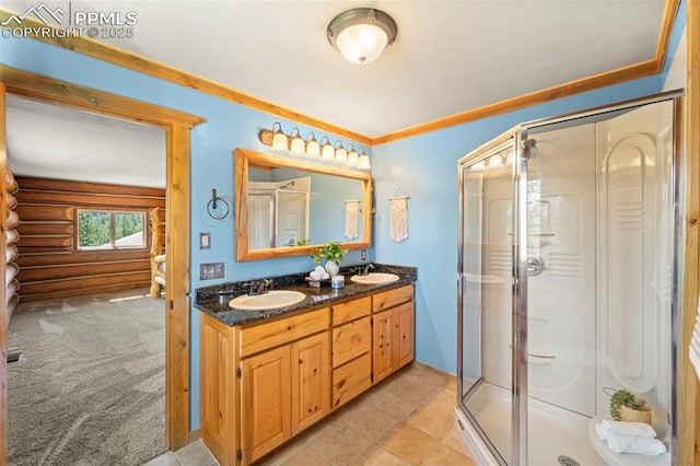 bathroom featuring ornamental molding, a shower with shower door, and vanity