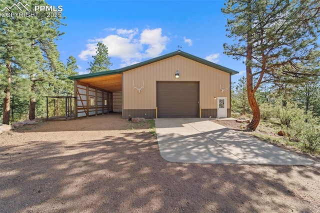 view of front of property with a garage and an outdoor structure