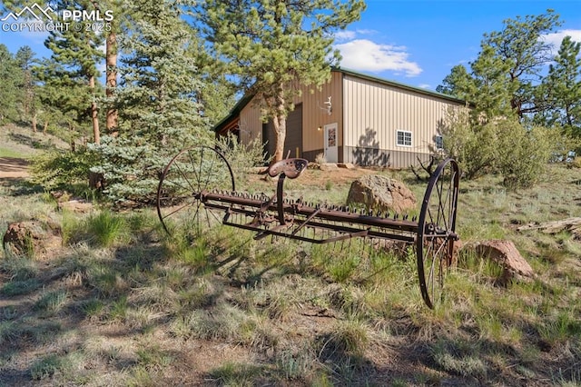 view of property exterior with an outbuilding