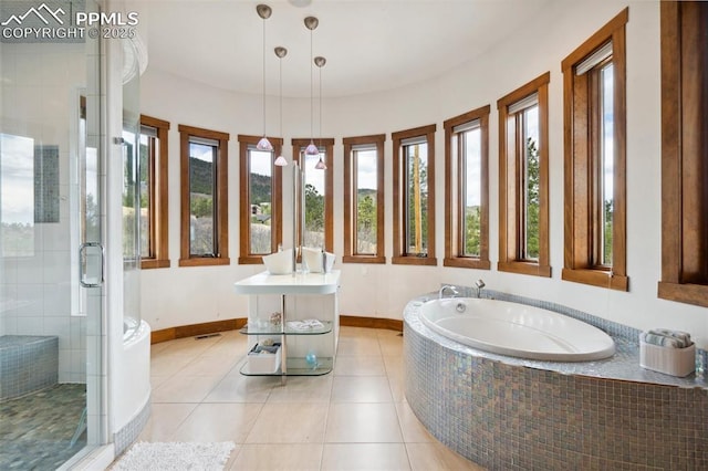 bathroom with independent shower and bath and tile patterned floors