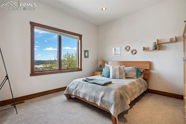 bedroom featuring light colored carpet