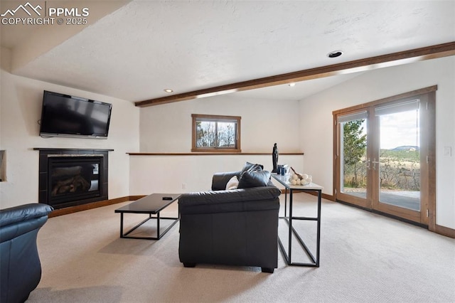 living room featuring beamed ceiling and light carpet