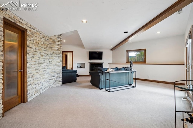 carpeted living room with beamed ceiling