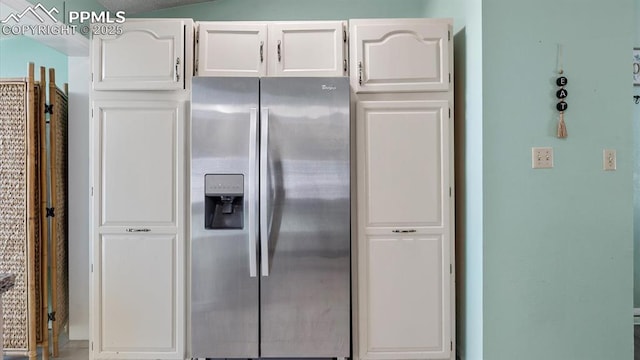 kitchen with stainless steel fridge with ice dispenser and white cabinets