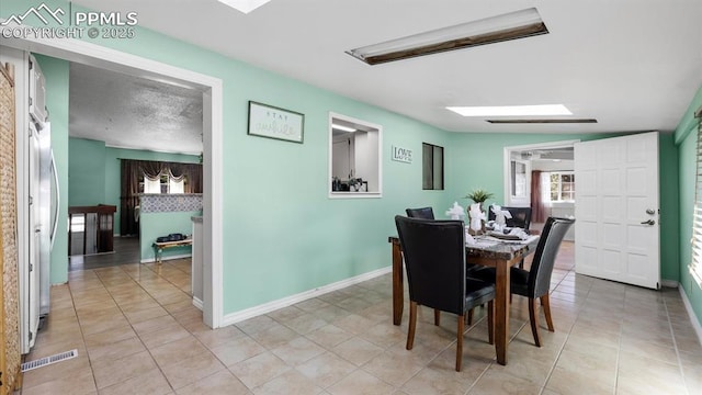 dining area with light tile patterned flooring