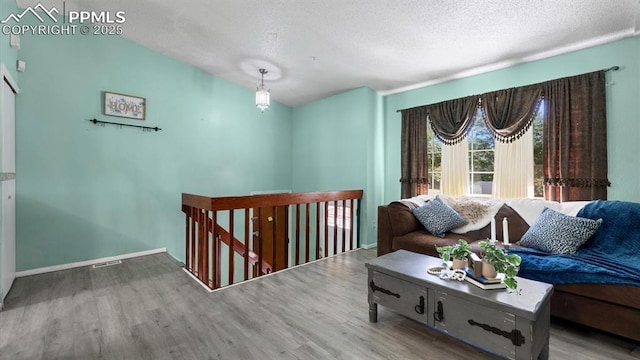 interior space featuring hardwood / wood-style flooring and a textured ceiling