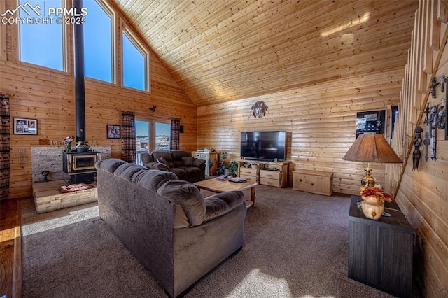 living room featuring wooden walls, high vaulted ceiling, carpet floors, wooden ceiling, and a wood stove