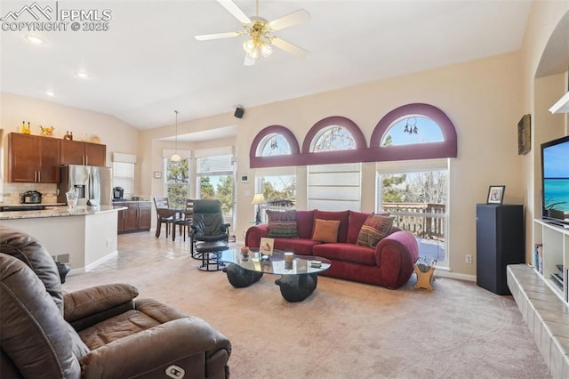 living room with a wealth of natural light, vaulted ceiling, and light colored carpet