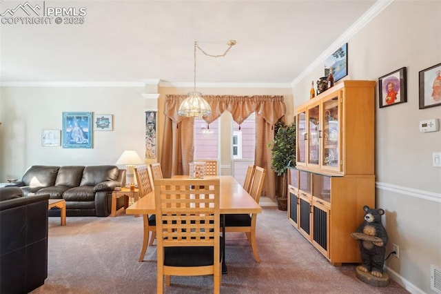 carpeted dining area featuring crown molding and a notable chandelier