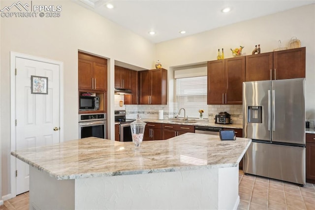 kitchen with sink, a center island, light tile patterned floors, stainless steel appliances, and light stone countertops