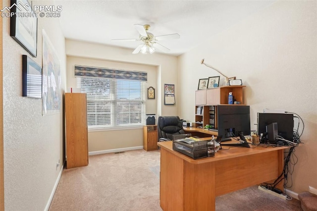 carpeted office featuring ceiling fan