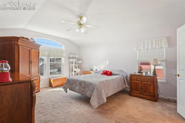 bedroom with multiple windows, vaulted ceiling, light colored carpet, and ceiling fan