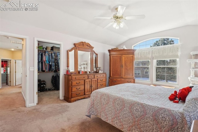 bedroom with lofted ceiling, a walk in closet, light colored carpet, a closet, and ceiling fan