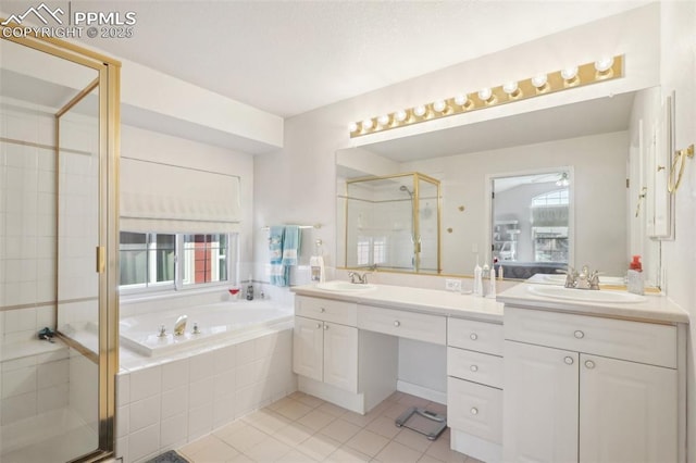 bathroom with vanity, tile patterned floors, and shower with separate bathtub