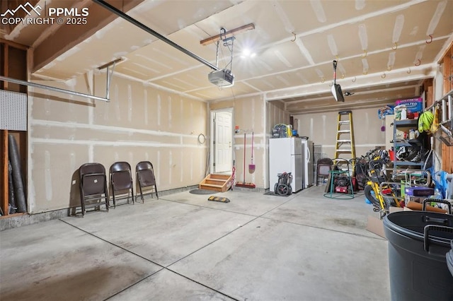 garage with a garage door opener and white fridge