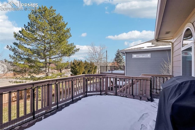 wooden deck featuring a grill