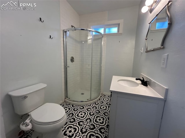 bathroom featuring vanity, toilet, an enclosed shower, and tile patterned flooring