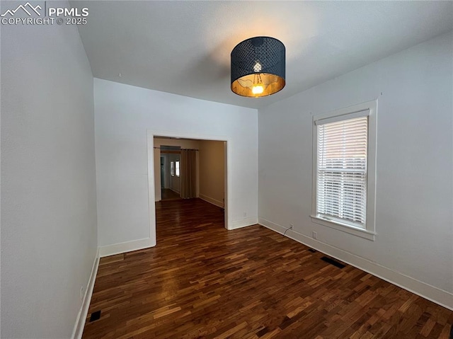 spare room with dark wood-type flooring