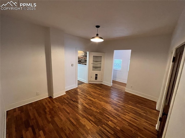 unfurnished dining area featuring dark hardwood / wood-style floors