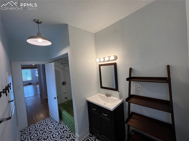 bathroom featuring vanity, hardwood / wood-style floors, and shower / washtub combination