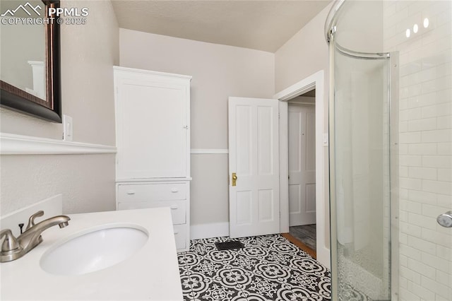 bathroom with vanity and a shower with door