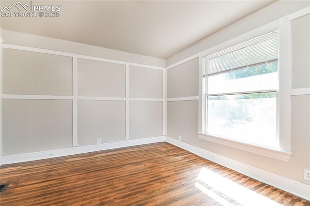 empty room with hardwood / wood-style flooring