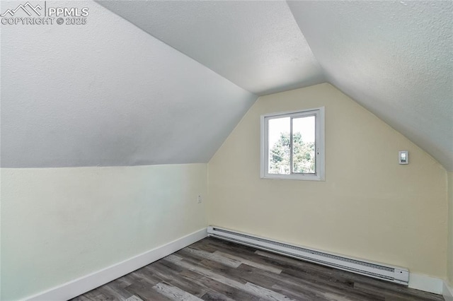 bonus room featuring lofted ceiling, dark hardwood / wood-style floors, a textured ceiling, and a baseboard heating unit