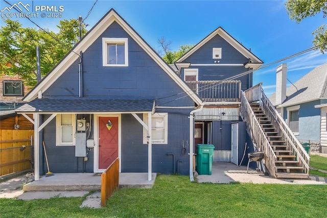 rear view of property with a yard