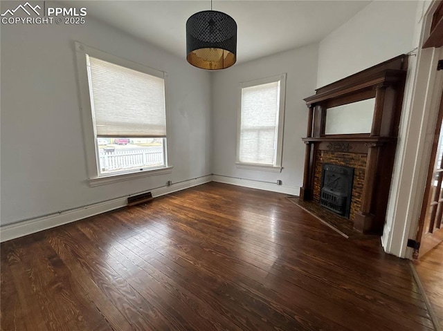 unfurnished living room featuring dark hardwood / wood-style flooring and a fireplace