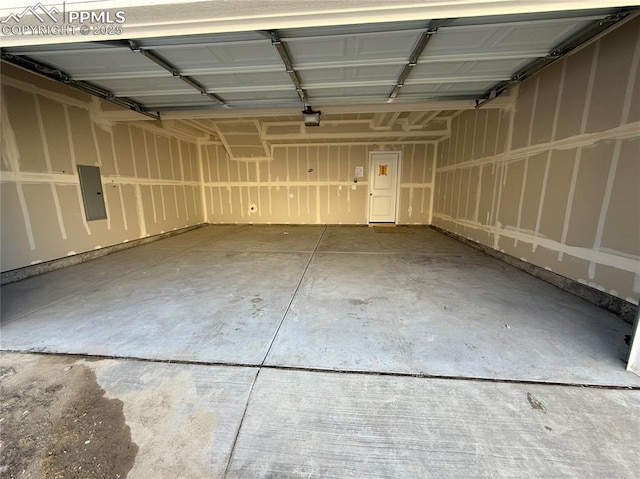 garage featuring a garage door opener and electric panel