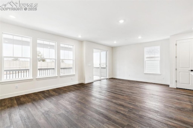 spare room with dark hardwood / wood-style flooring