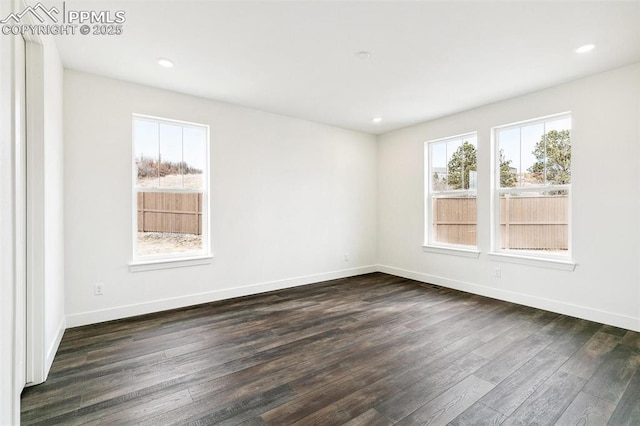 spare room featuring dark wood-type flooring