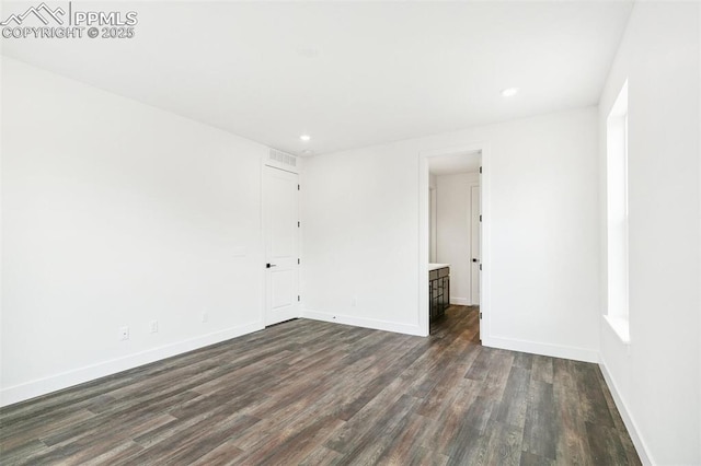 spare room with dark wood-type flooring