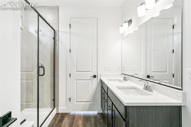 bathroom with vanity, a shower with door, and hardwood / wood-style floors