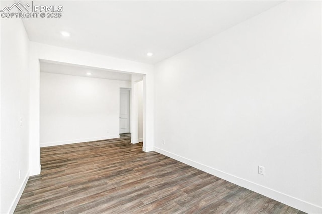 empty room with dark hardwood / wood-style flooring