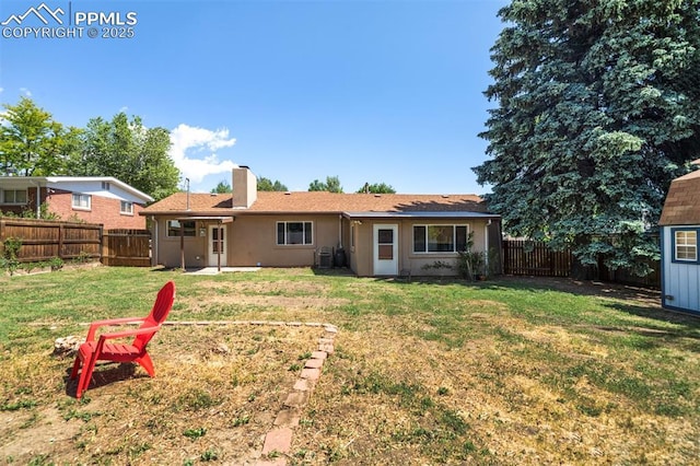 rear view of property featuring a yard