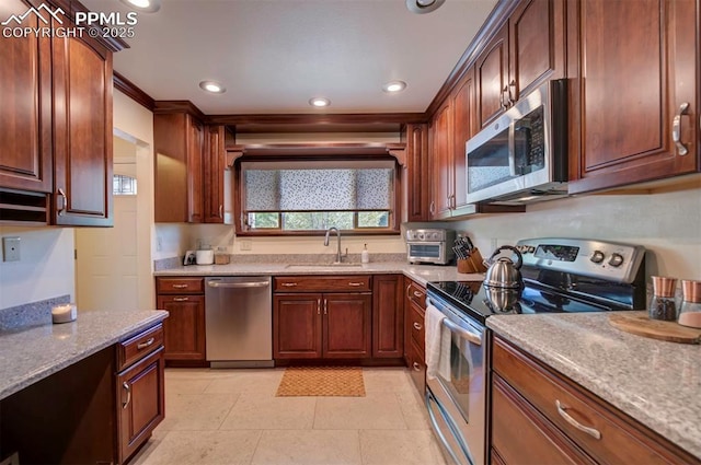 kitchen featuring sink, light tile patterned floors, light stone countertops, and appliances with stainless steel finishes