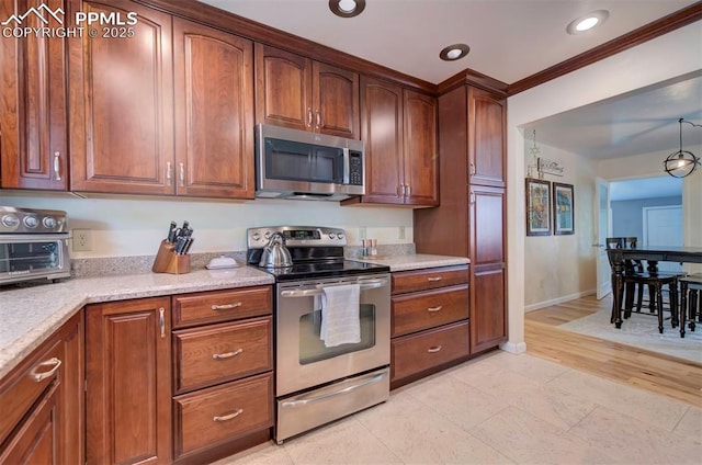 kitchen featuring light stone counters, ornamental molding, and appliances with stainless steel finishes