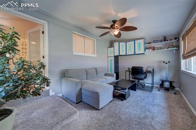 living room with ceiling fan and carpet