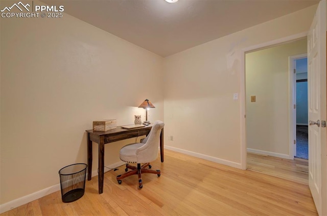 office with light hardwood / wood-style flooring