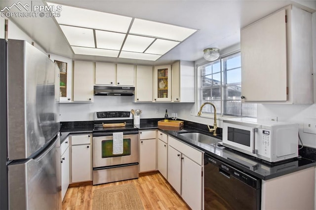 kitchen featuring sink, light hardwood / wood-style floors, white cabinets, and appliances with stainless steel finishes