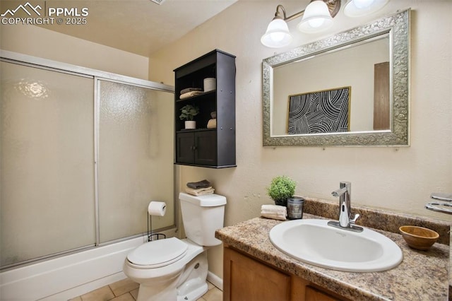 full bathroom featuring vanity, tile patterned floors, shower / bath combination with glass door, and toilet