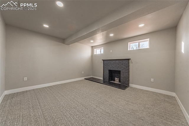 basement featuring carpet floors and a fireplace