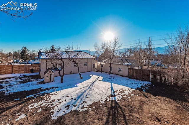 snowy yard featuring a mountain view