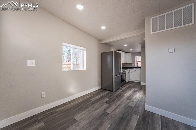 kitchen with white cabinetry, sink, dark wood-type flooring, and high quality fridge