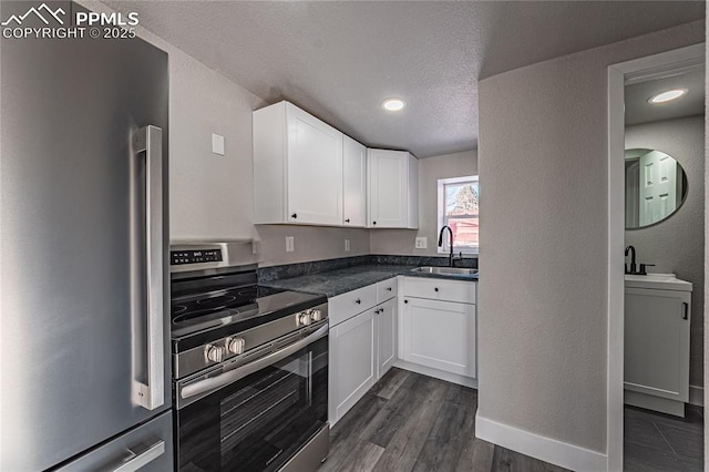 kitchen with dark wood-type flooring, sink, a textured ceiling, appliances with stainless steel finishes, and white cabinets