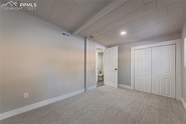 unfurnished bedroom featuring carpet floors and a closet