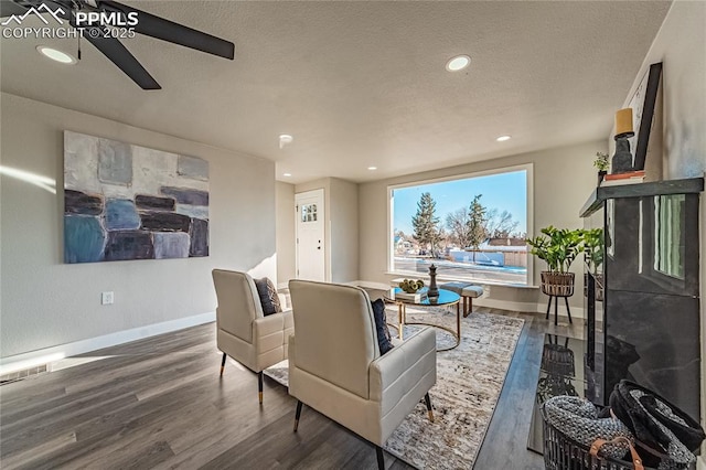 living room with dark hardwood / wood-style flooring and a textured ceiling