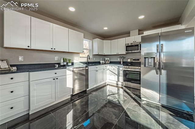 kitchen with stainless steel appliances, sink, and white cabinets